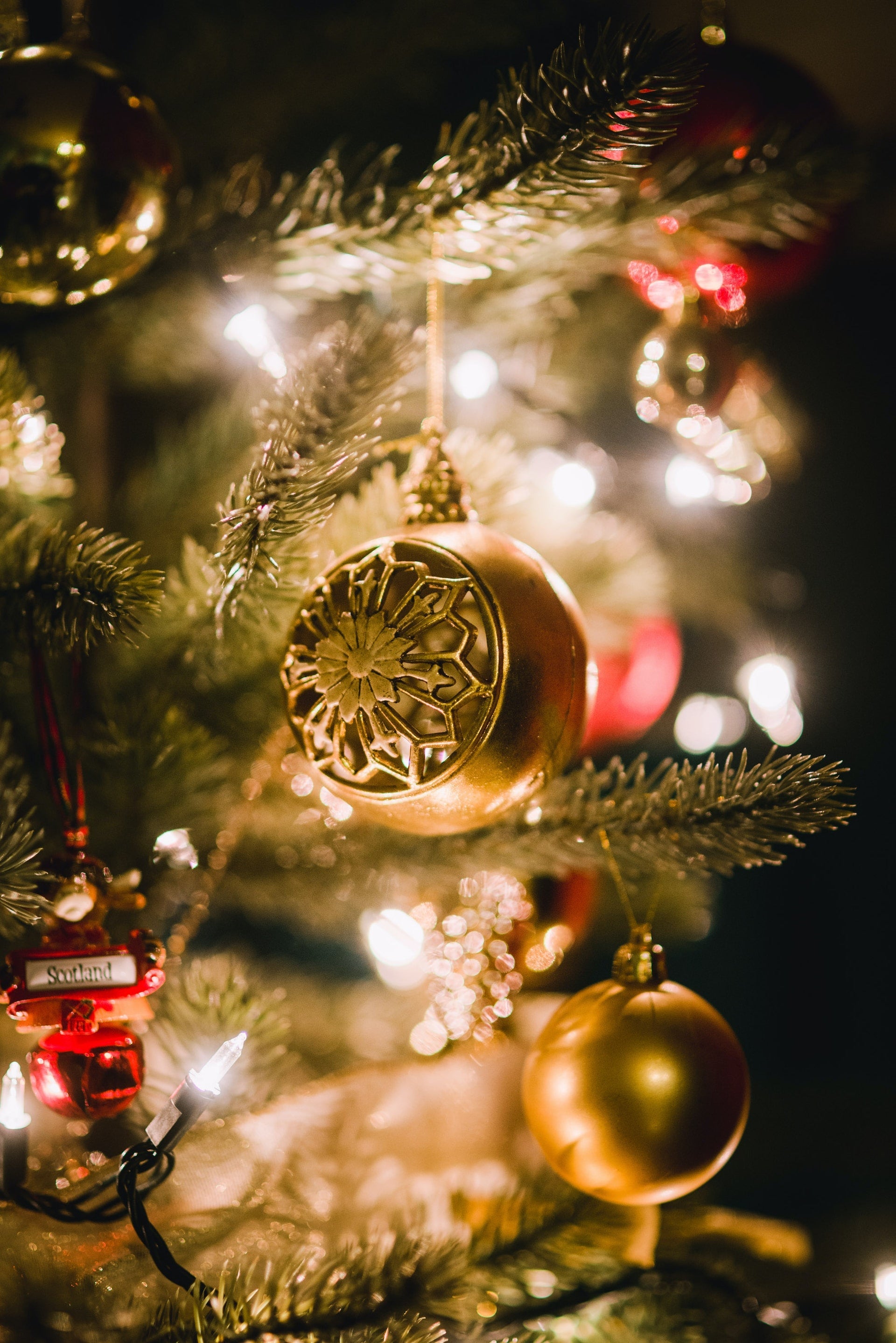 What is the symbolism of the ornaments hung on the Christmas tree?